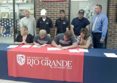 Morgan High School's Clinton Campbell (center left) and Derek Dingey (center right) sign with Rio Grande